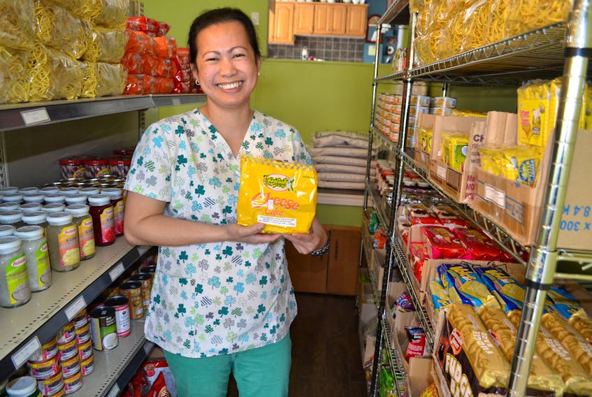 Besides ingredients for meal-making, Ruby Gadbilao demonstrates her Bloomfield store also carries ready-to-eat snacks, like cheesecakes.