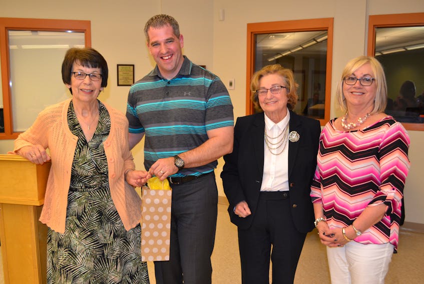 Paul Young, administrator of Community Hospitals West, receives a gift of appreciation during the annual meeting of the O’Leary Community Health Foundation. Thanking him for the work he does for health care are executive members, from left, Eva Rodgerson, Fairley Yeo and Eileen Brown.