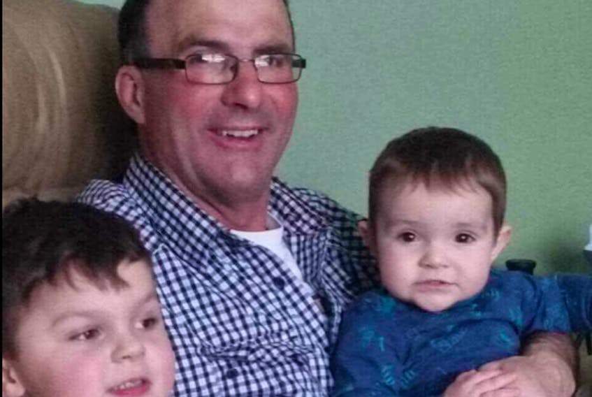 Glen DesRoches, 55, with two of his grandchildren, Holden and Kayden. DesRoches and his friend, Moe Getson, have been missing since their fishing boat sank Tuesday. – Joanne DesRoches photo -