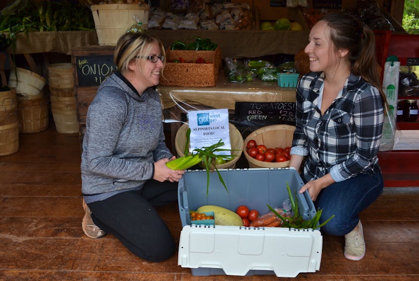 Emily Arsenault, right, program coordinator with Western Region Sport and Recreation Council, helps Webbs Vegetables’ staff member Bobby-Jo Bridges pack a box for the WRSRC’s Veggie Box program. Council programming this year will place more emphasis on healthy eating.