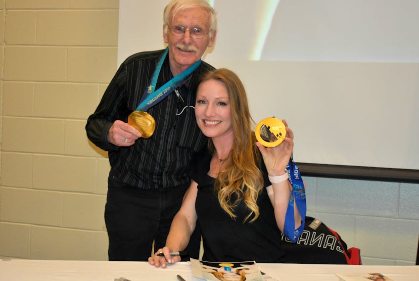 Allan Vincent from Borden-Carleton poses as he gets ready to add another photo of his sports hero, Heather Moyse, to his treasured binder. He was one of the people who attended a special homecoming event in Moyse’s honour last night in Summerside.