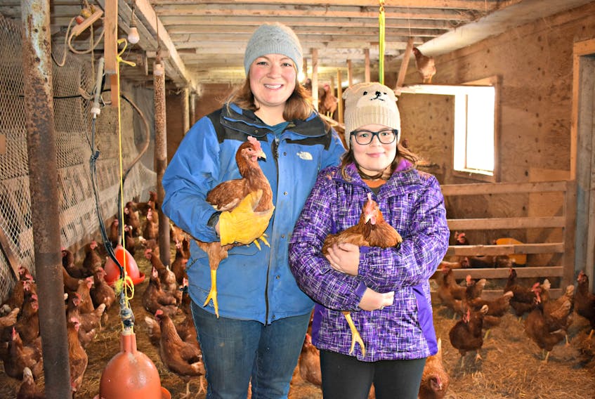 Sally Bernard and her daughter Lucy inside the chicken coop where the rare egg was found.
