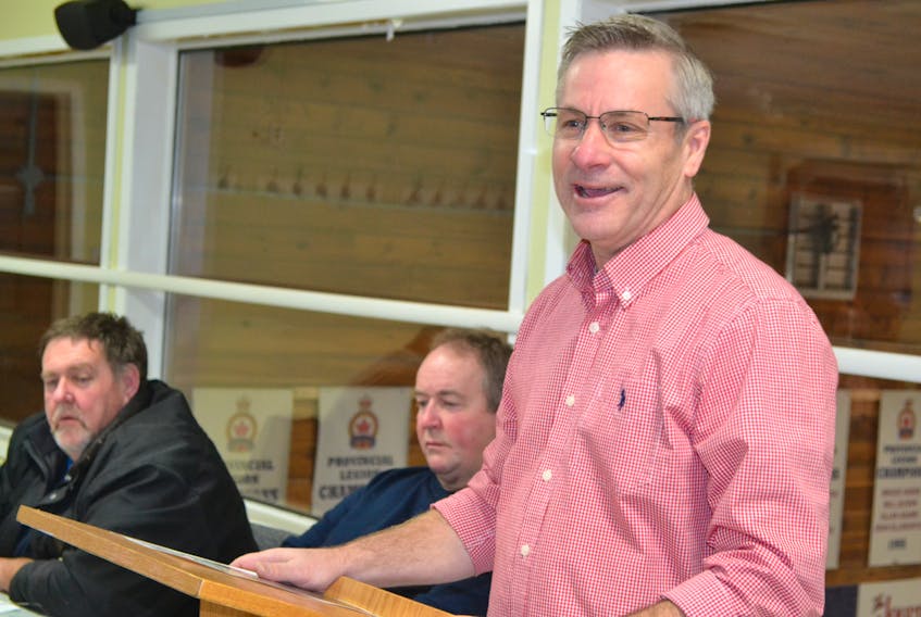 Agriculture and Fisheries Minister Robert Henderson, speaking during the annual meeting of the Western Gulf Fishermen’s Association. Looking on are WGFA president Francis Morrissey, left, and director Lloyd Phillips.