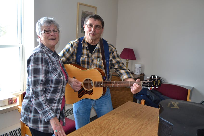 Phyllis Weatherbie and Dale Ryan entertain patients in a Western Hospital room that doubles as a family conference room and an activity area. They are part of the first wave of volunteers to sign up since a volunteer program was established incorporating the manors and hospitals in Alberton and O'Leary.