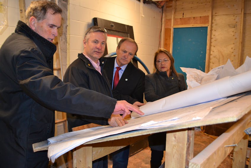 Larry McQuaid, from left, project manager for the John J. Sark Memorial School renovation and expansion project, shows project blueprints to O’Leary-Inverness MLA Robert Henderson, Egmont MP Bobby Morrissey and Lennox Island First Nation chief Matilda Ramjattan.