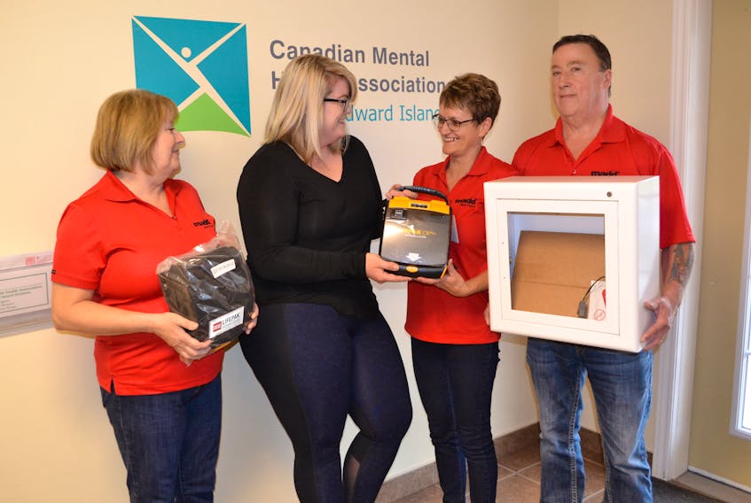 Julia Ramsay, second left, site manager at Canadian Mental Health Association Alberton, accepts a donation of an automated external defibrillator for the facility from the West Prince Chapter of Mothers Against Drunk Driving (MADD) Canada. Making the presentation are, from left Trudy Betts, Edna Gallant and Bruce Gallant.