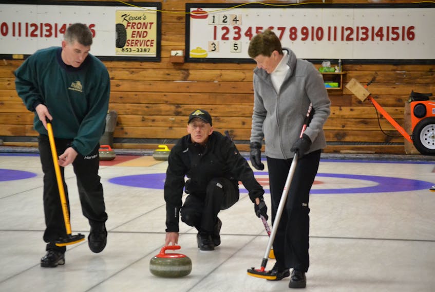 Daryl MacDonald from the Western Community Curling Club turns his stone over to sweepers, John Ellsworth and Cheryl Bell. MacDonald opened play at the P.E.I. Provincial Mixed Curling Championship in Alberton with a 7-5 win over the Corey Miller rink from the Silver Fox.