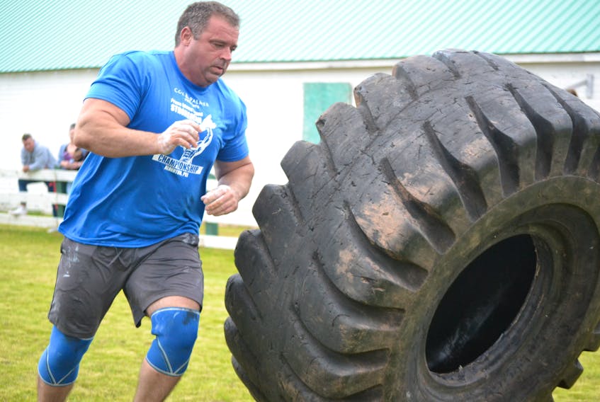 Grant Connors runs to the other side of the 800-pound tire during the tire flip event in the Strongest Man in P.E.I. Competition, held Thursday night in Alberton during the opening day of the Prince County Exhibition. The Kentville, NS resident was the overall winner, picking up where he left off the last time he competed in Alberton seven years ago.