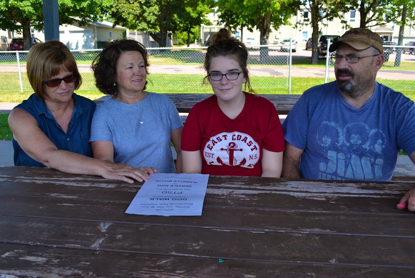 Isabelle Buote, second right, is accompanied by, from left, her tutor, Lissa Profit, her in-school support worker, Carol Morgan, and her father, Brian, as she describes the hope she is placing in a July 29 PTSD awareness walk. The 15-year-old was recently diagnosed with a form of post-traumatic stress disorder called disassociation.