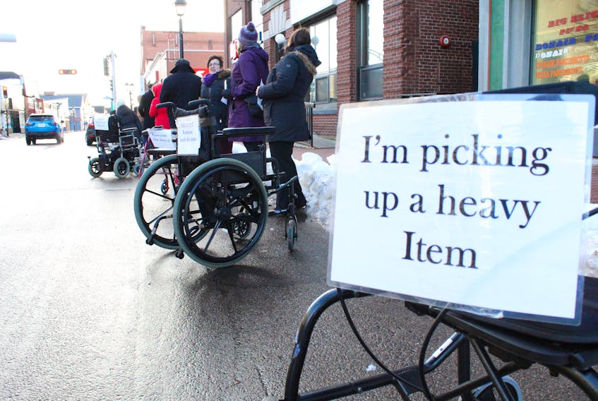 P.E.I. Council of People with Disabilities staged a silent protest in downtown Summerside Monday in recognition of the International Day of Disabled Persons. The event was designed to bring awareness of the abuse of blue designated parking spaces by blocking regular parking spaces with wheelchairs and walkers.