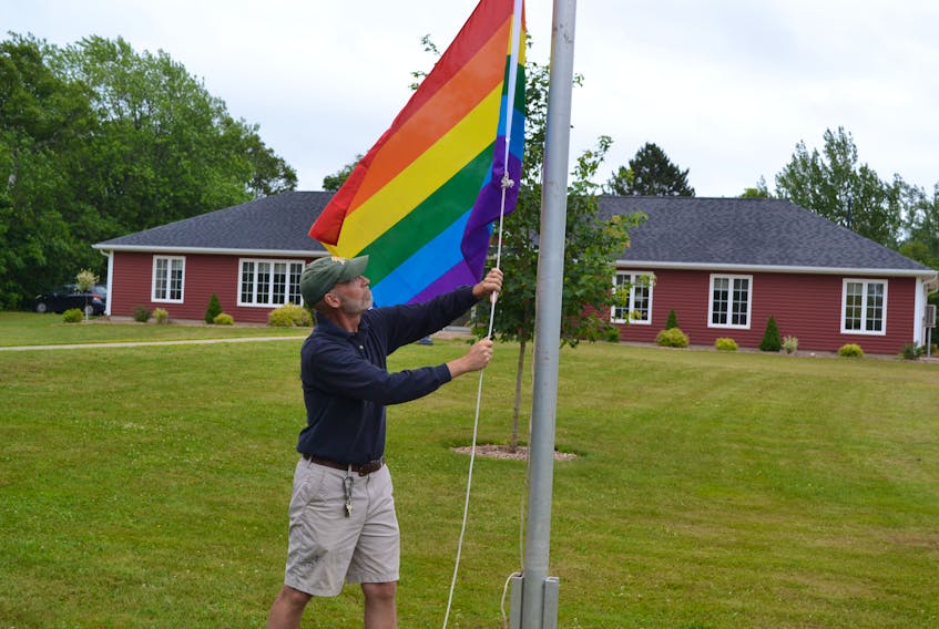 Alberton maintenance worker Garth Davey raised the rainbow flag for Pride Week in 2018. It was taken down after the town received complaints. Town council is not permitting the flag to be flown on the town flagpoles this year. - File photo