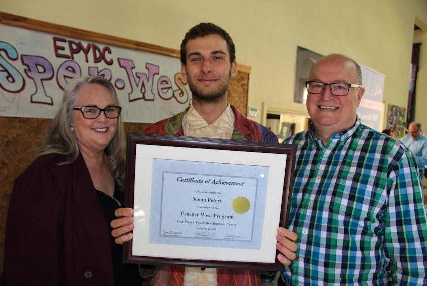 Nolan Peters, centre, graduated from the Prosper West Program of the East Prince Youth Development Centre, Thursday. Presenting Peters with his diploma was Joyce Newcombe, program coordinator, left, and Ken Culleton, program facilitator.