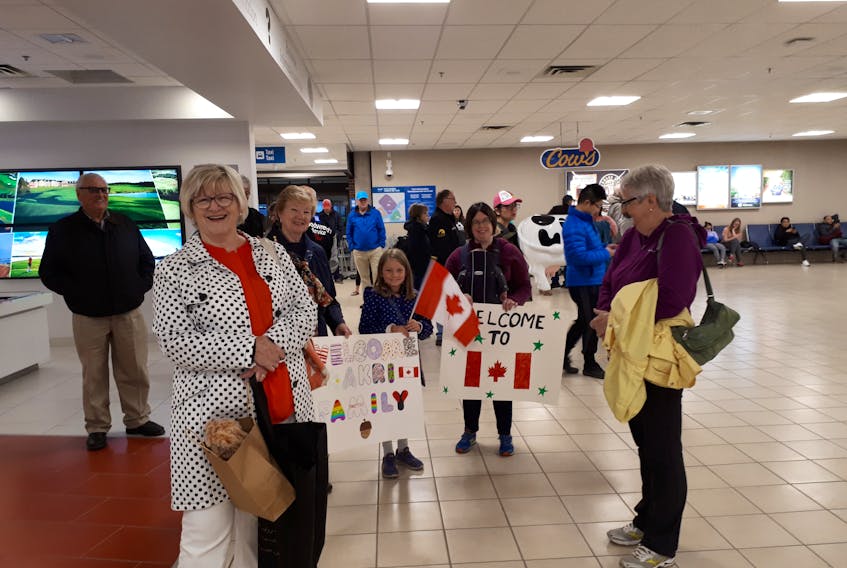 Members of the Tyne Valley and Area Sponsorship Committee excitedly wait at the Charlottetown airport early Friday for the arrival of a Syrian refugee family. The committee has found a home for the mother and father and their two children in Summerside. The children were born in a refugee camp in Beirut.