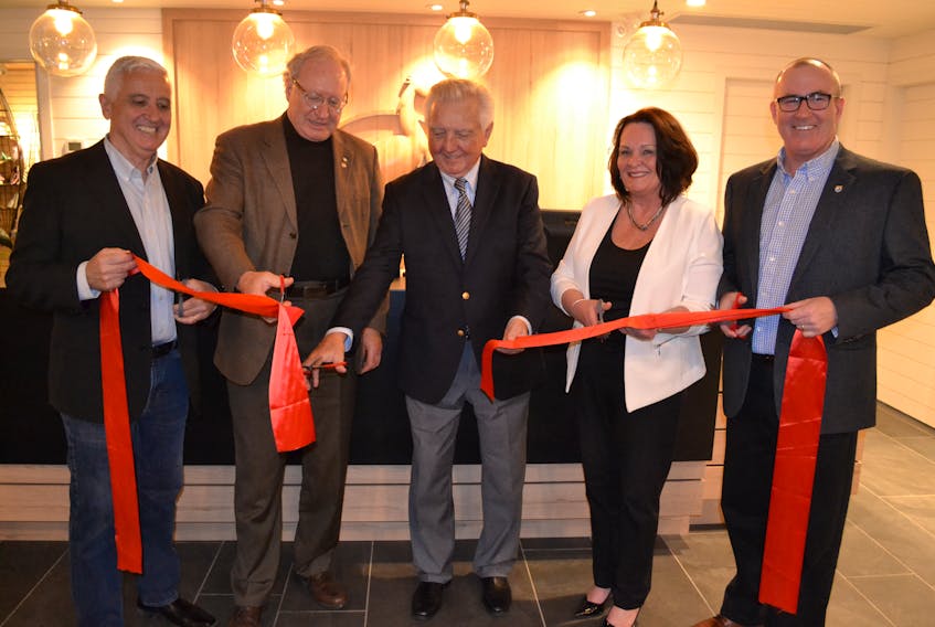 Mill River Resort owner, Don McDougall, center, is accompanied by, from left, Pat Murphy, Minister of Rural and Reginal Development; Premier Wade MacLauchlan, hotel operations manager Louise Arsenault and Economic Development and Tourism Minister Chris Palmer in cutting the ribbon during official opening ceremonies for the renovated resort.