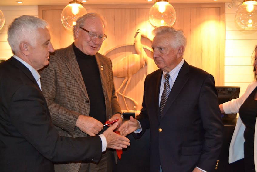 Premier Wade MacLauchlan, center, chats with Pat Murphy, left, Minister of Rural and Regional Development and Mill River Resort owner Don McDougall during the resort’s official opening celebrations in June.
