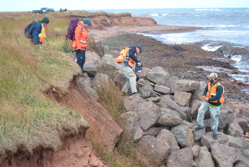 Members of P.E.I. Ground Search and Rescue make their way onto a beach at North Cape Wednesday during their search for two missing fishermen. Local residents out searching subsequently found the body of Glen DesRoches at North Cape on Sunday and of Moe Getson near Cambellton on Monday.