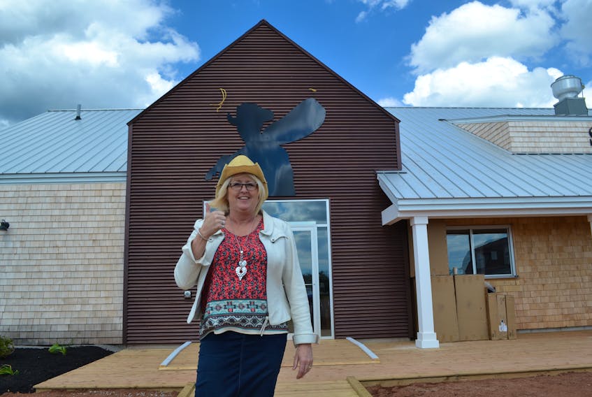 Tignish Initiatives general manager Anne Arsenault, in front of the Stompin' Tom Centre in Skinners Pond prior to last summer's official opening. Tignish Town Councillors have expressed disappointment that Tignish Initiatives is scheduling its second annual Stompin' Tom Fest on the same weekend as their Irish Moss Festival. Arsenault said no one from the town had communicated any of that disappointment to Tignish Initiatives about the schedule.