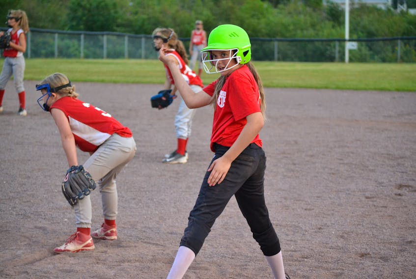 O’Leary Reds’ Madison Donnell looks for instruction from her coach after getting on base during their game against Nova Scotia on Saturday. Guarding the bag is Nova Scotia first baseman, Julia Costain. The Reds’ finished tournament play with a 2-4 summary while Nova Scotia earned a play-off berth in third place with a 3-3 record.
