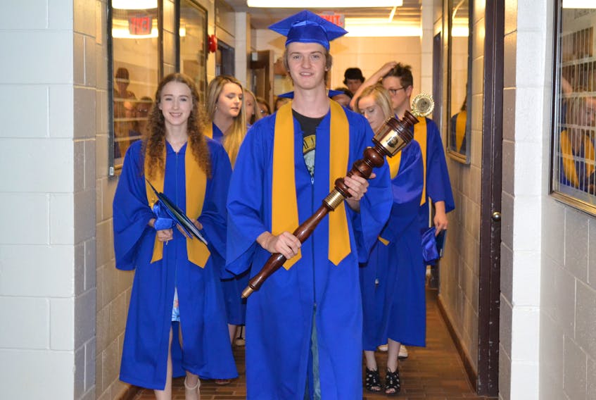 Student council president Griffen Arsenault carries the mace as he leads the Class of 2018 out of Westisle Composite High School gymnasium Thursday night at the conclusion of his school’s 39th annual graduation ceremony. The 141 graduates shared in scholarships, bursaries and prizes valued at more than $800,000.