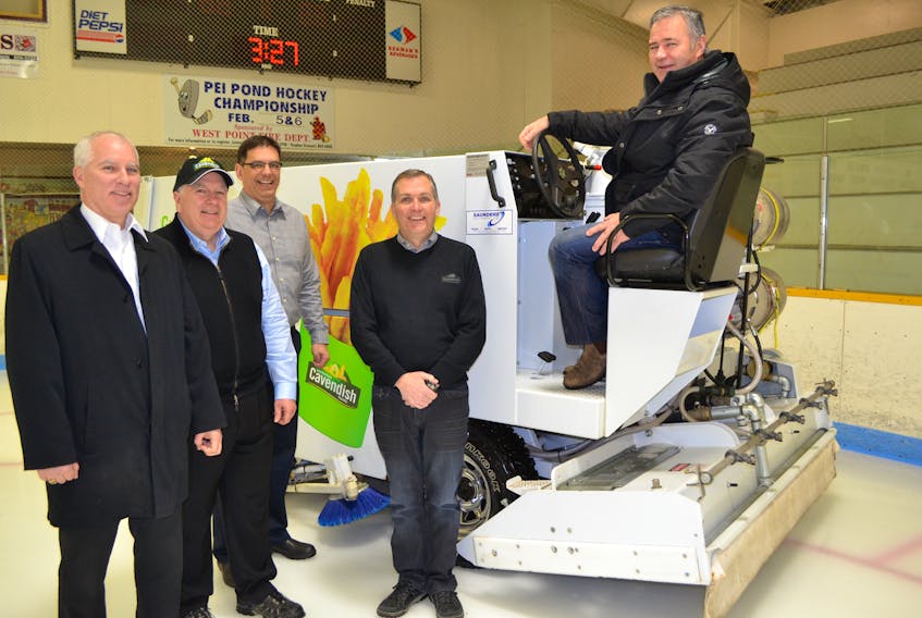 O'Leary Community Sports Centre Board member David Harris describes the features of the arena's new Zamboni to Cavendish Farms officials, from left, Wayne McDonald, senior vice president, corporate relations; Robert Irving, President and CEO; Bill Meisner, vice president, operations and Ron Clow general manager and senior vice president.
