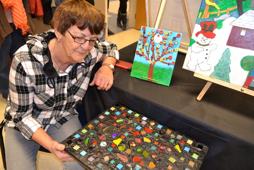 Lena Brown says the table she incorporated her late husband’s guitar picks into as part of the Deblois Acadian Centre’s Love to Pieces art program will be beside her with refreshments while camping out at bluegrass festivals this year.