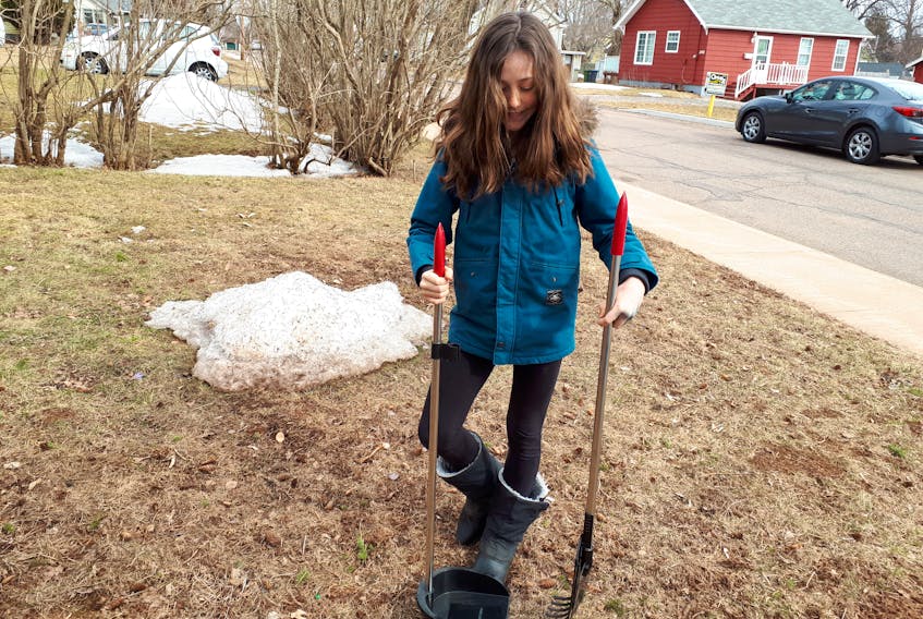 (Bryce Doiron/Journal Pioneer)
Iyla Kilbride practises scooping poop in her front yard in Summerside. The 10-year-old is turning the common chore into a summer job.