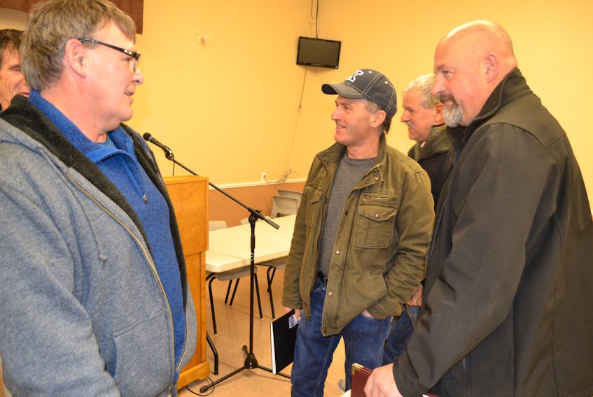 Lobster fisherman Gerald Arsenault, left, chats with Prince County fishermen’s Association president Lee Knox and executive member Michel Myers following the association’s special meeting Wednesday. The fishermen met to consider a response to the Maritime Fishermen’s Union’s proposal for a night fishing curfew. The PCFA will put the question on a mail-in ballot.
