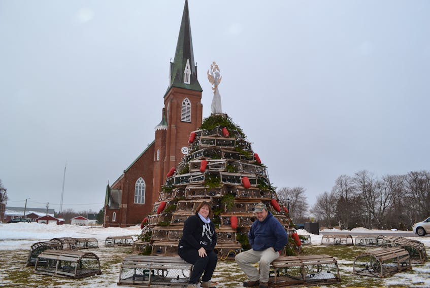 Tignish Recreation director Tina Richard chats with Mark Arsenault at the base of the Fishermen Tree in Tignish. Arsenault wrote a song about a September 18 fishing boat disaster which claimed the life of two Tignish fishermen. He sang it during the official lighting of the Fishermen Tree Sunday. The tree is in memory of all deceased fishermen.