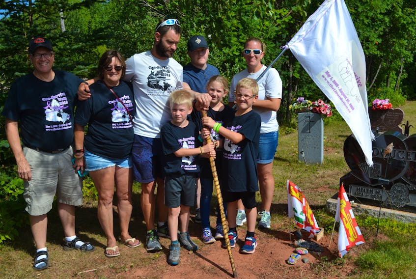 Jimmy Lefebvre, back row, center, pauses at his father’s final resting place in Palmer Road while accompanied by family members, back row from left, father-in-law Manny Keller, mother Rita, son Declyn, wife Kristi and, front row from left, children Kayden, Dylan and Kallyn.