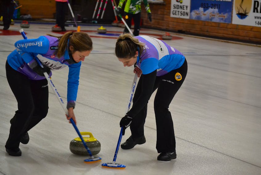 Jane DiCarlo, left and Whitney Jenkins, mate and lead on the Veronica Smith rink, sweep a stone during the P.E.I. Scotties. Smith takes a 5-1 record into tonight’s 7p.m. ‘C’ Qualifier against Suzanne Birt (3-2). Sarah Fullerton (4-2) awaits them in Sunday’s play-offs.