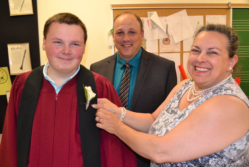 École Pierre-Chiasson Class of 2019 graduate Rhys Gallant gets help with his corsage from Lisa Merman, guest speaker for the graduation ceremony in Deblois. Looking on is school principal Ghislain Bernard. Marmen is student services co-ordinator with the Prince Edward Island French Language School Board.