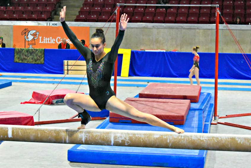 Liah Mah, 13, is perfectly poised on the balance beam during Saturday’s competition at the Eastern Canadian gymnastics championships at Credit Union Place in Summerside.