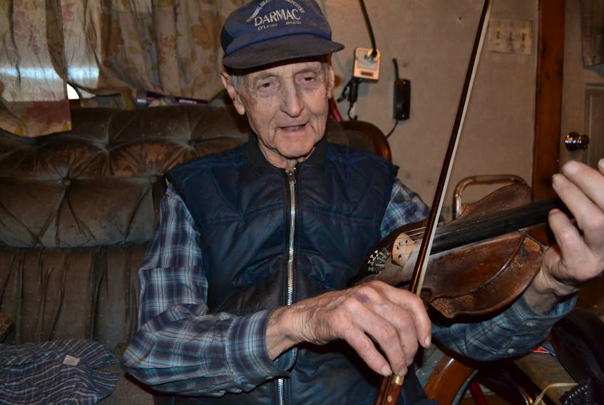 Harry Lecky offers up a tune on the fiddle. Friends and relatives often stop in to his ancestral home to enjoy a visit and to play some tunes together. Lecky, who turned 90 on April 18, estimates he plays three to four times a week.