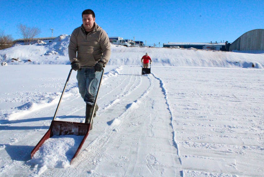 Chris Newell and David Allan, both with the Bedeque Bay Environmental Management Association, worked Monday to clear Summerside’s west-end ice pond for skating. They hoped to have their work done and the surface ready to go by late Monday afternoon.