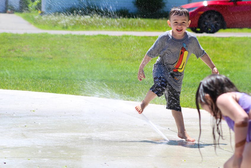 Clay Parsons, 3, beat the heat recently by playing with other kids at the City of Summerside’s waterpark in Leger Park. The water play area is now open for the season and there is now a washroom and concessions stand available to park users.