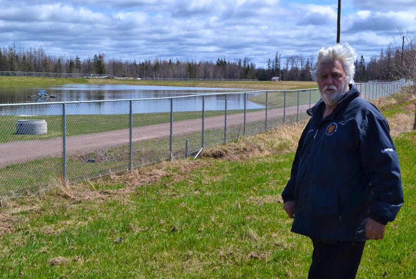 O’Leary Mayor Eric Gavin views the town’s wastewater treatment lagoon from outside the facility’s fence. The town is open to recommendations on how to fix corrosion problems believed to have been caused by a toxic algae bloom.