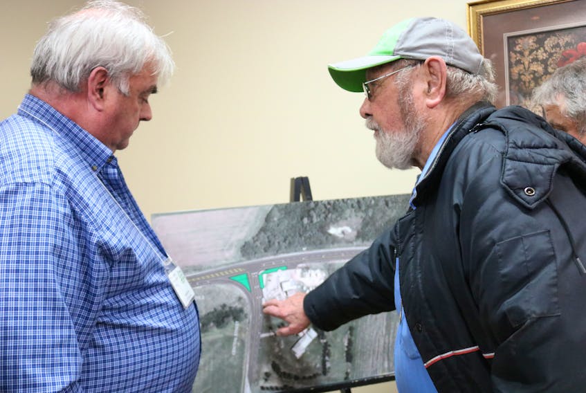 Art Lockhart, right, raises his concerns to chief engineer Stephen Yeo for the Granville Street/Route 2 roundabout construction.