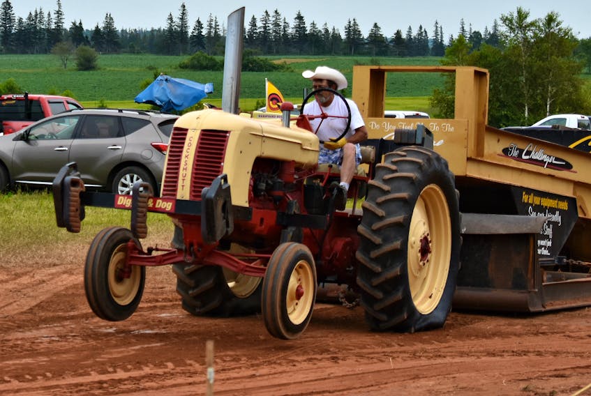 Brendan Johnston feels the strain of the pull as the front of his vintage tractor is lifted into the air.