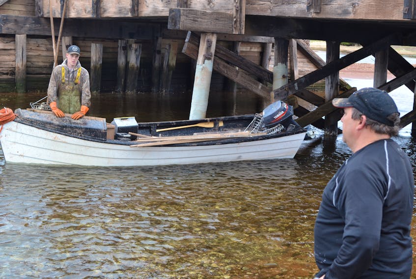 Kenneth Arsenault, right, president of the P.E.I. Shellfish Association catches up with oyster fishermen on the quantity and quality of spring oysters. Arsenault believes a decline in landings is due to sea lettuce interfering with the annual spat run.