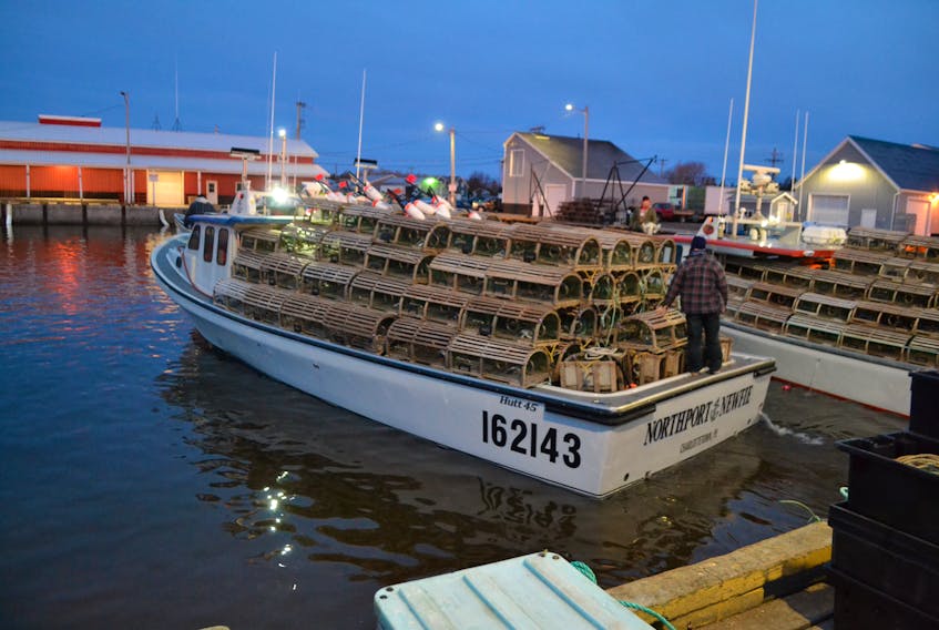 A fishing boat leaves the wharf in Northport Friday morning with its first load of lobster traps.  After four delays due to wind, the spring lobster season got underway i call conditions under a clear sky.