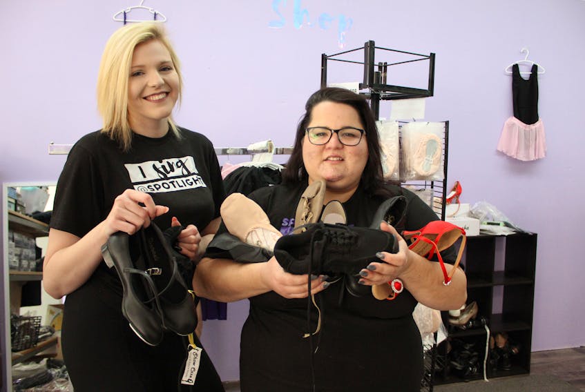 Digital Producer Amanda Doucette, left, and Executive Director Reasha Walsh show off some of the shoe selection available at the Spotlight Shop. Spotlight School of Performing arts just launched its ‘Spotlight Presents’ podcast Feb. 26.