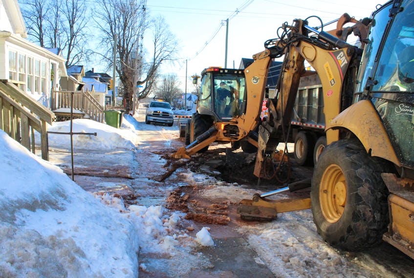 City equipment digs through an icy mess to fix a water main leak Jan. 15 on Harvard Street in Summerside.
