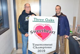 Three Oaks Axewomen head coach Garth Turtle, left, and Three Oaks Senior High School athletic director Joel Arsenault display the championship banner up for grabs at this weekend’s 38th Sweetheart senior girls’ basketball tournament. Play begins Friday evening, and the championship game is Saturday at 3 p.m.