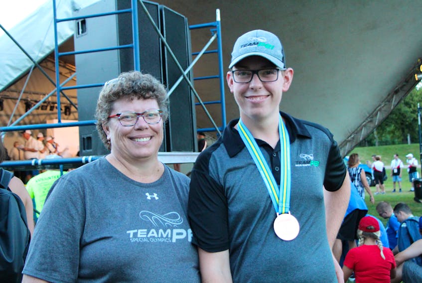 Roy Paynter poses with his mother and coach, Sarah Paynter, at the Special Olympics Canada 2018 Summer Games in Antigonish, N.S. Paynter has won for medals – two gold and two bronze – in the first two days of swimming competition. Special Olympics P.E.I.
