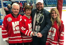 Summerside native Devan Praught poses with his parents, Kevin and Nelda Praught, and his fiancé, Lindsay Richardson, after coaching the Notre Dame Hounds to the 2018 Telus Cup Canadian midget AAA hockey championship in Sudbury, Ont., on April 29.