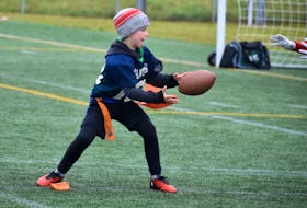 Nine-year-old Coby Maund of the Summerside Spartans focuses on catching a pass during the Spartans Bowl flag football tournament at Eric Johnston Field in Summerside on Saturday.