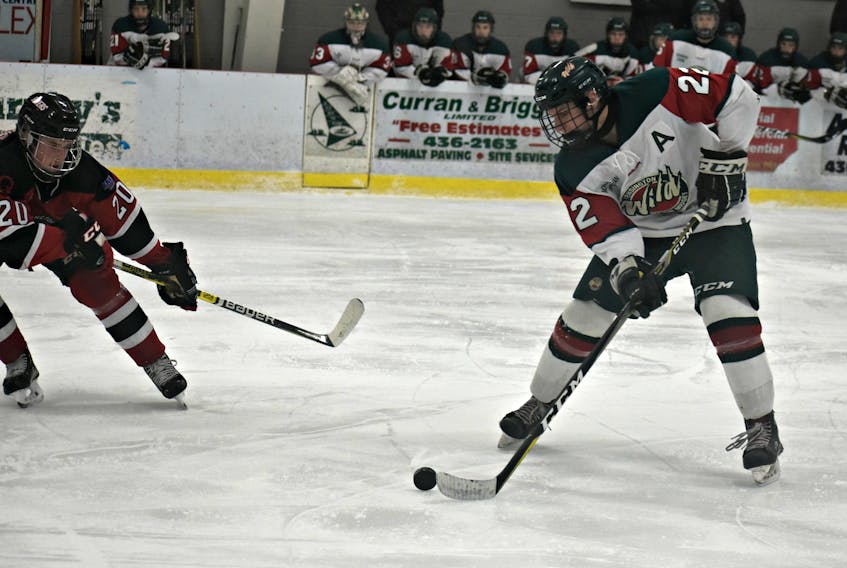 Kensington Wild forward Dixon MacLeod, 22, looks to pass the puck while being defended by the Moncton Flyers’ Cole Cormier. The action took place during a New Brunswick/P.E.I. Major Midget Hockey League game in Kensington on Saturday night. The teams were tied 1-1 in the second period when play was suspended due to an unexpected power outage.
