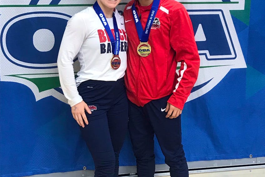 Hannah Taylor and Ligrit Sadiku pose with the gold medals they won at the Ontario University Athletics (OUA) wrestling championships in Guelph on Saturday.