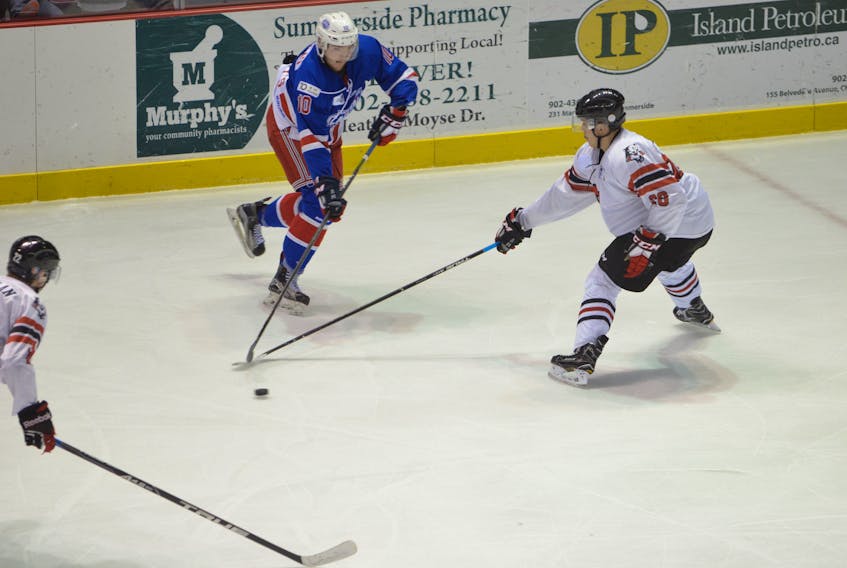 Summerside D. Alex MacDonald Ford Western Capitals forward Kallum Muirhead mades a pass while the Truro Bearcats’ Graham Rutledge defends in MHL (Maritime Junior Hockey League) action Sunday night. The Caps posted a 5-2 win over the Bearcats at Eastlink Arena before 2,200 fans in the first-ever Centennial Classic.
