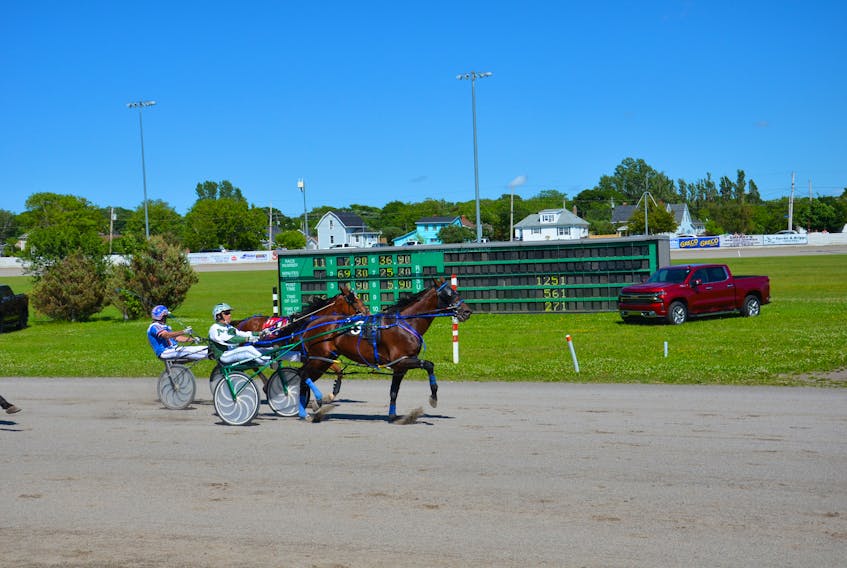 Kenny Arsenault, left, drives Czar Seelster to a 1:54.3 victory in the first of two $5,000 Township Chevy and Noonan Petroleum Governor’s Plate eliminations at Red Shores at Summerside Raceway on Sunday afternoon. Down On My Luck and driver Jason Hughes finished second.